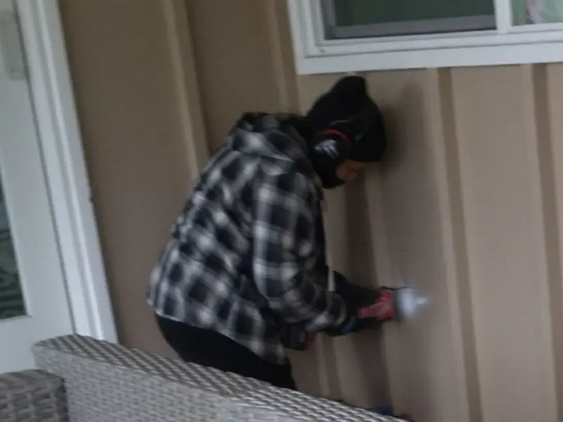 Professional electrician installing an exterior outlet in Marquette
